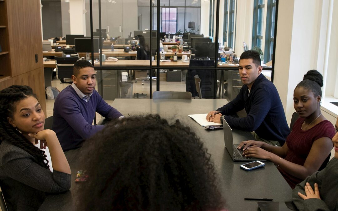 a group of people sitting around a table