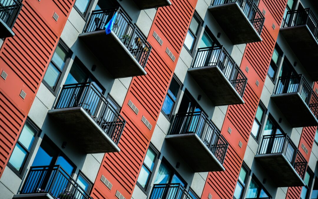 a tall red building with balconies and balconies