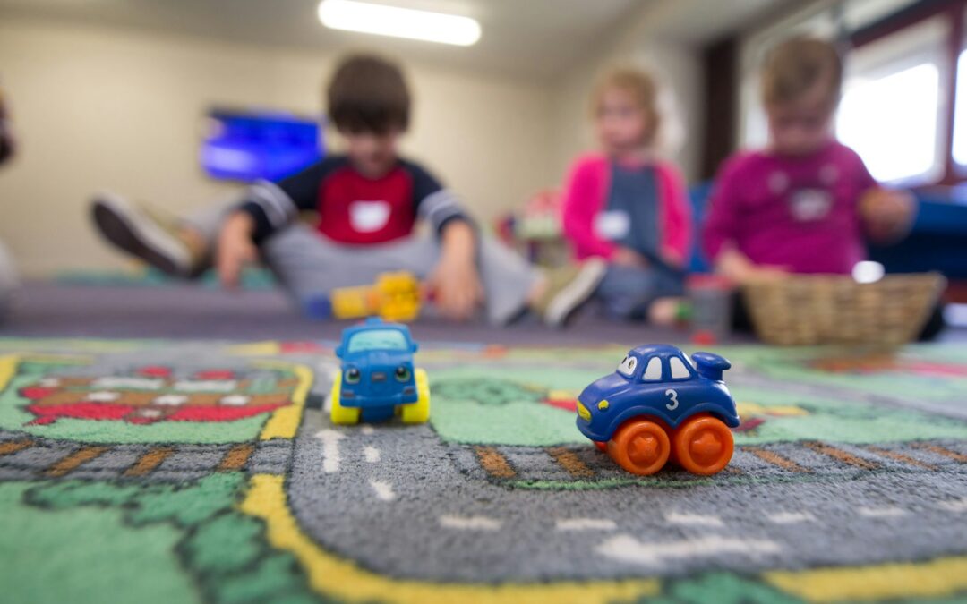 a group of children playing with toys on the floor